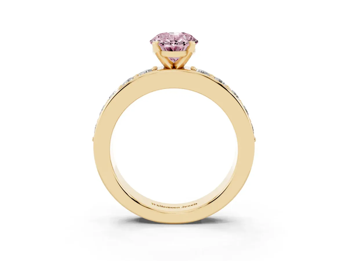 Fancy Pink Oval Cut Diamond Engagement Ring with Channel Set Round Band and Prong Setting Yellow gold