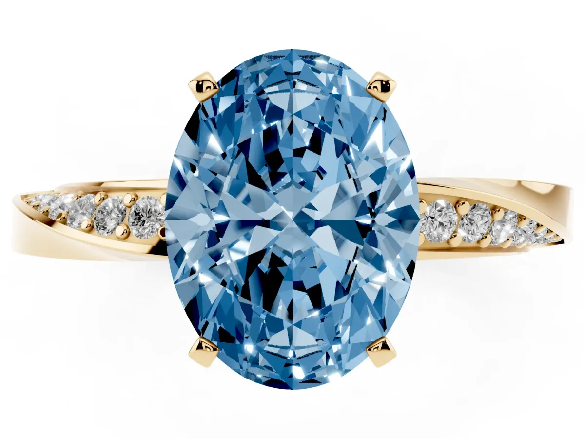 Fancy Blue Oval Cut Diamond Engagement Ring with Side Stone Accents and Four-Prong Setting Yellow gold