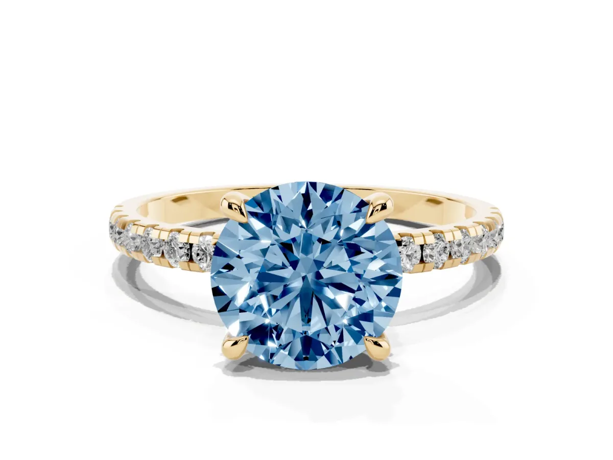 Fancy Blue Round Cut Diamond Brilliant Solitaire Ring with Pavé Band and Four-Prong Setting Yellow gold