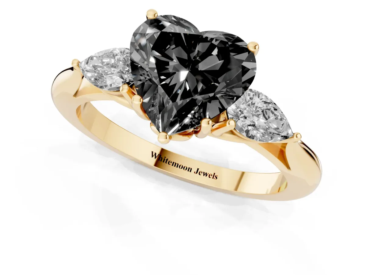Fancy Black Three-Stone Heart Cut Brilliant Diamond Solitaire Ring with Tapered Band and Four-Prong Setting Yellow gold