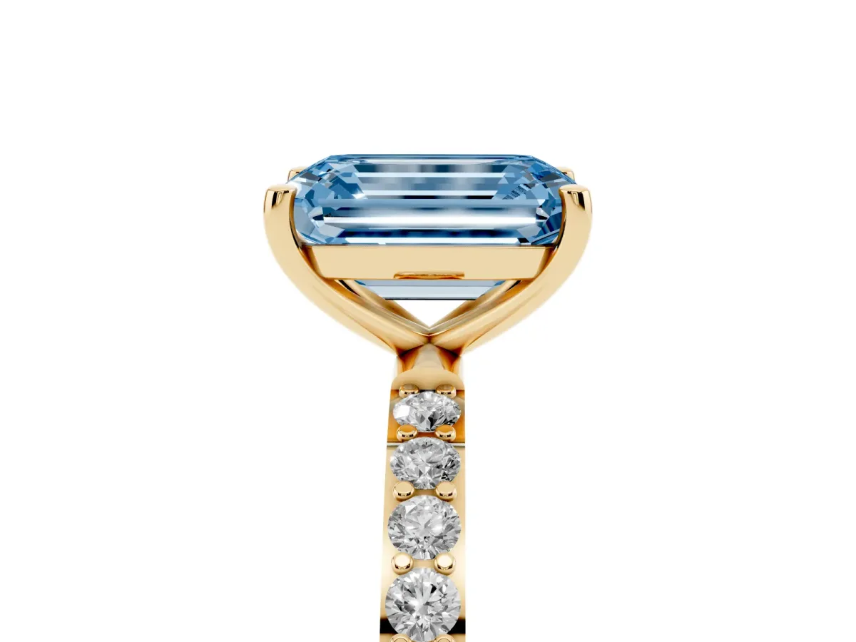 Fancy Blue Emerald Cut Diamond Solitaire Ring with Round Pavé Shoulders and Prong Setting Yellow gold