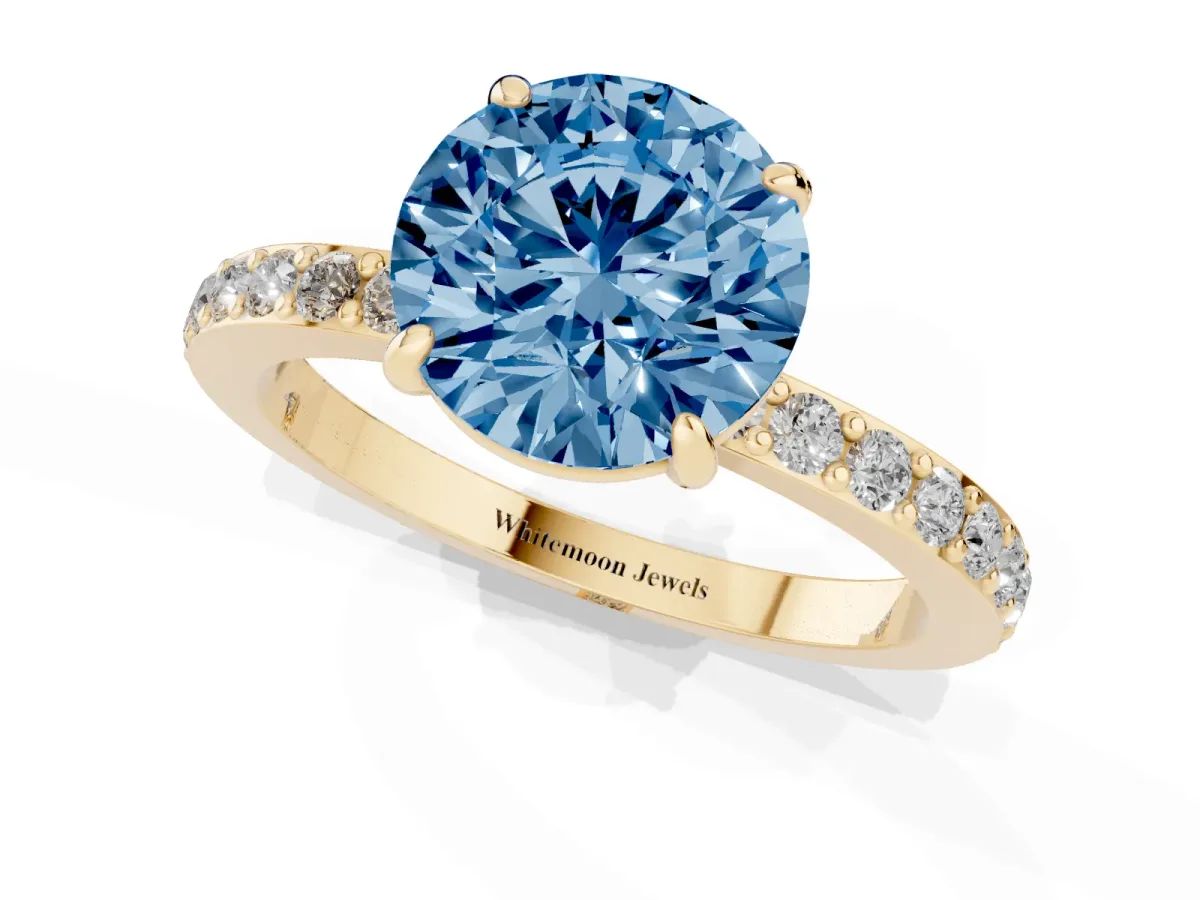 Fancy Blue Round Cut Diamond Pavé Engagement Ring with Round Accents and Prong Setting Yellow gold