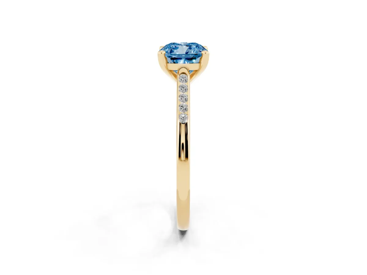 Fancy Blue Cushion Cut Diamond Solitaire Ring with Channel Set Round Band and Prong Setting Yellow gold