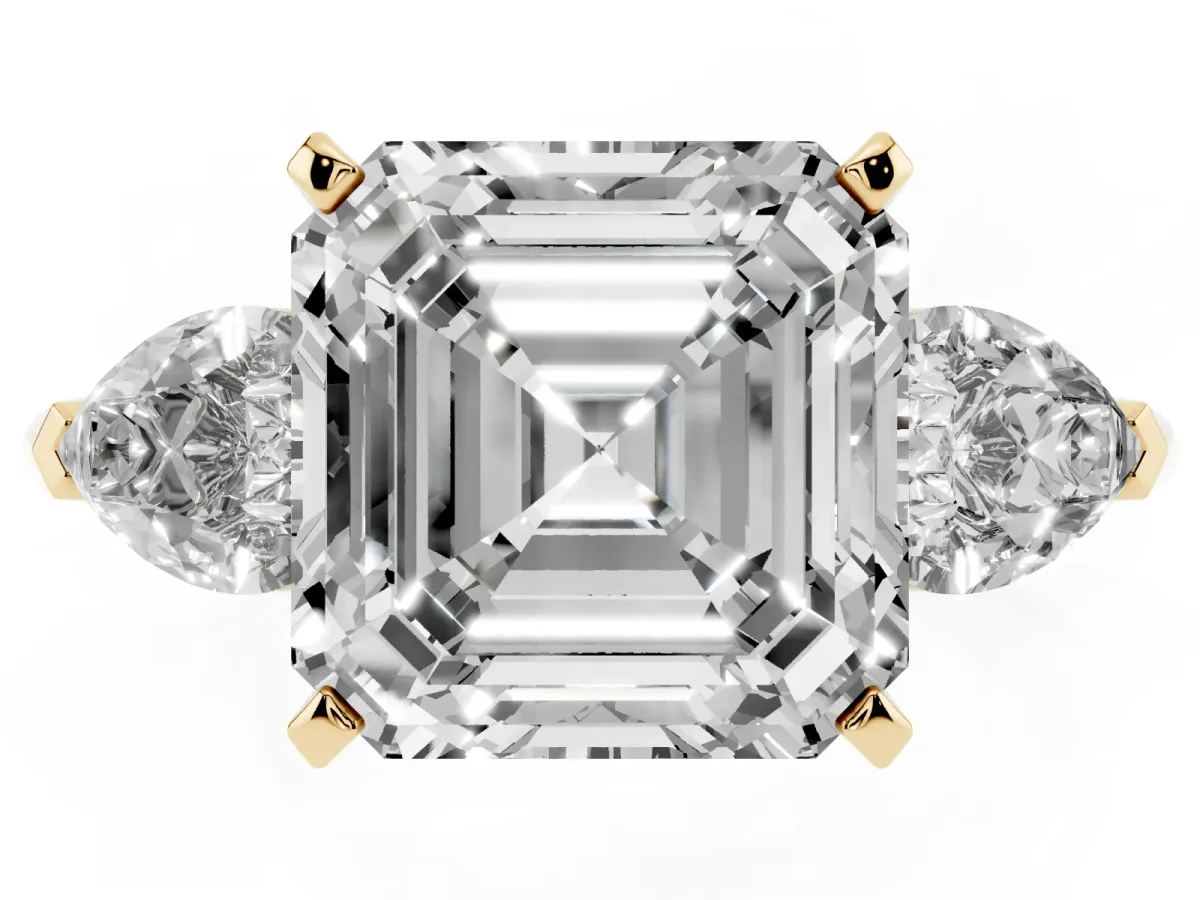 Three-Stone Asscher Cut Diamond Ring with Pear Side Stones and Four-Prong Setting Yellow gold