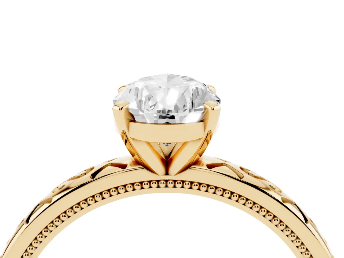 Pear Cut Solitaire Engagement Ring with Scrollwork Band and Four-Prong Setting Yellow gold
