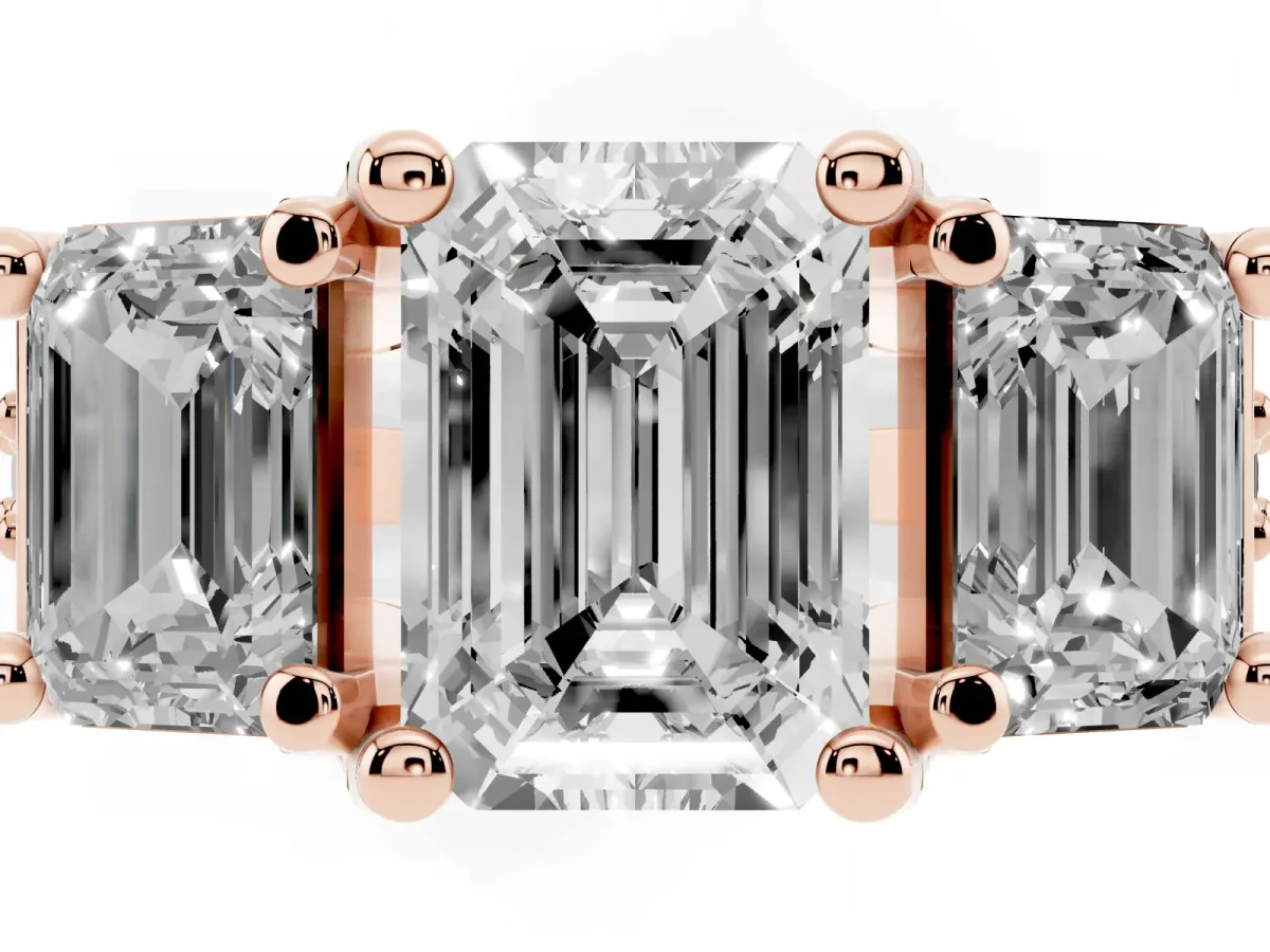Emerald Cut Diamond Three-Stone Ring with Channel Set Band and Four-Prong Setting Rose gold