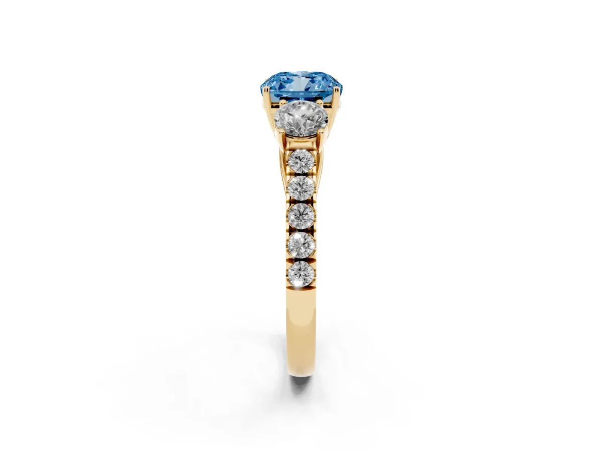 Fancy Blue Cushion Cut Cut Diamond Three-Stone Ring with Round Side Stones and Pavé Band Yellow gold