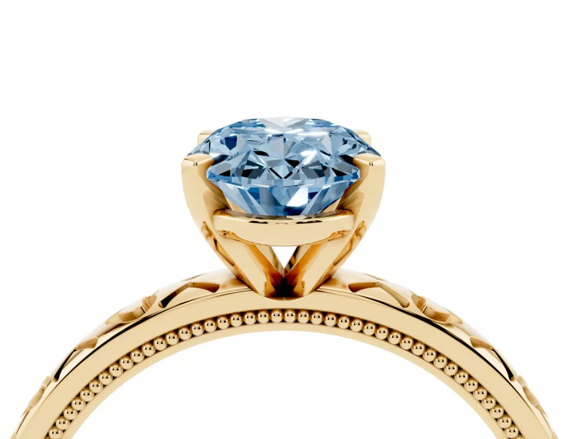 Fancy Blue Oval Cut Solitaire Diamond Engagement Ring with XO Engraved Band and Four-Prong Setting Yellow gold