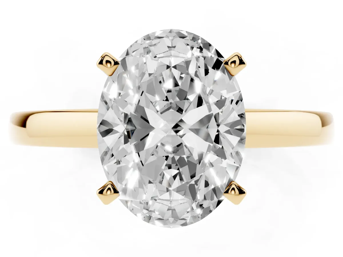 Oval Cut Solitaire Diamond Engagement Ring with Four-Prong Setting on a Classic Band Yellow gold