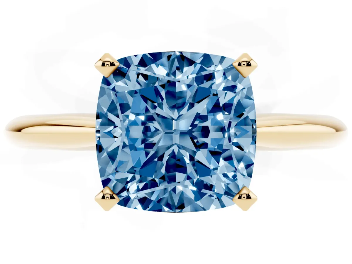 Fancy Blue Cushion Cut Cut Solitaire Ring with Four-Prong Setting on a Classic Band Yellow gold