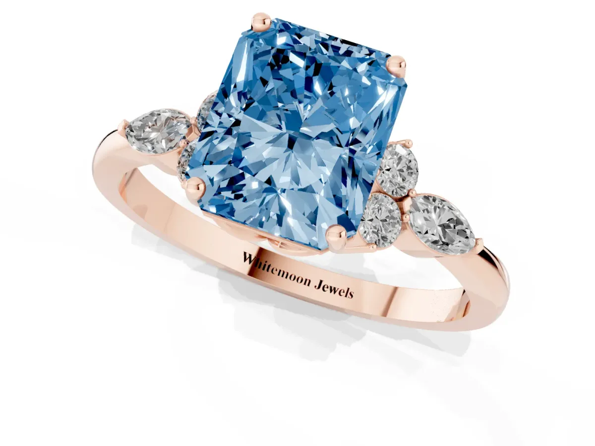 Fancy Blue Radiant Cut Brilliant Diamond Solitaire Ring with Pear Side Stones and Four-Prong Setting Rose gold