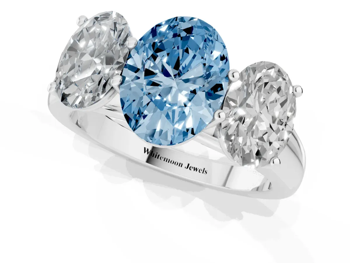 Fancy Blue Oval Cut Three-Stone Diamond Ring with Prong Setting on a Classic Band Platinum