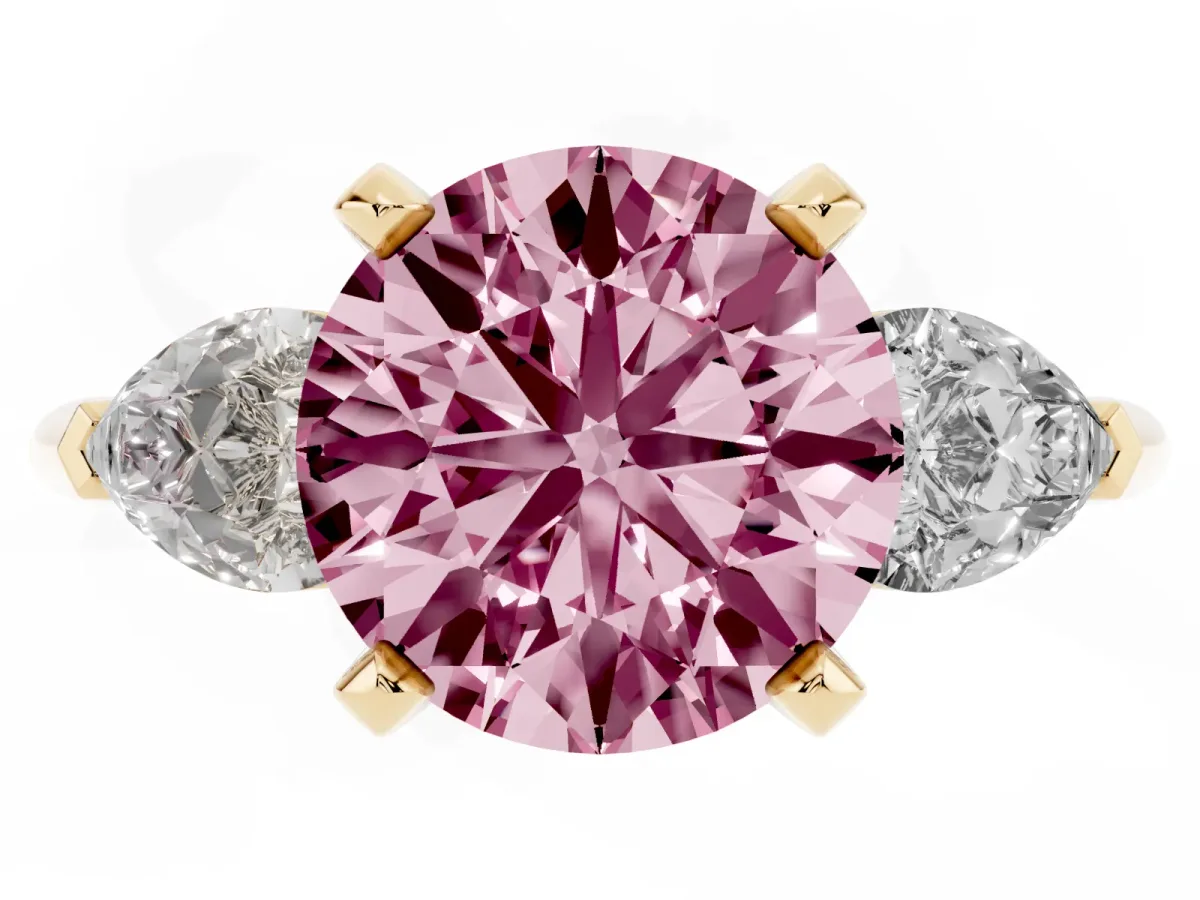Fancy Pink Three-Stone Round Cut Diamond Ring with Pear Side Stones and Four-Prong Setting Yellow gold
