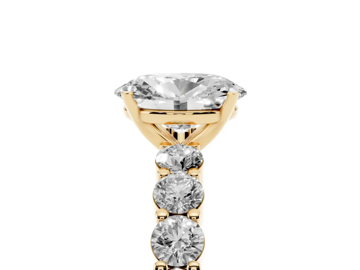 Oval Cut Diamond Solitaire Ring with Shared Prong Round Side Stones Yellow gold