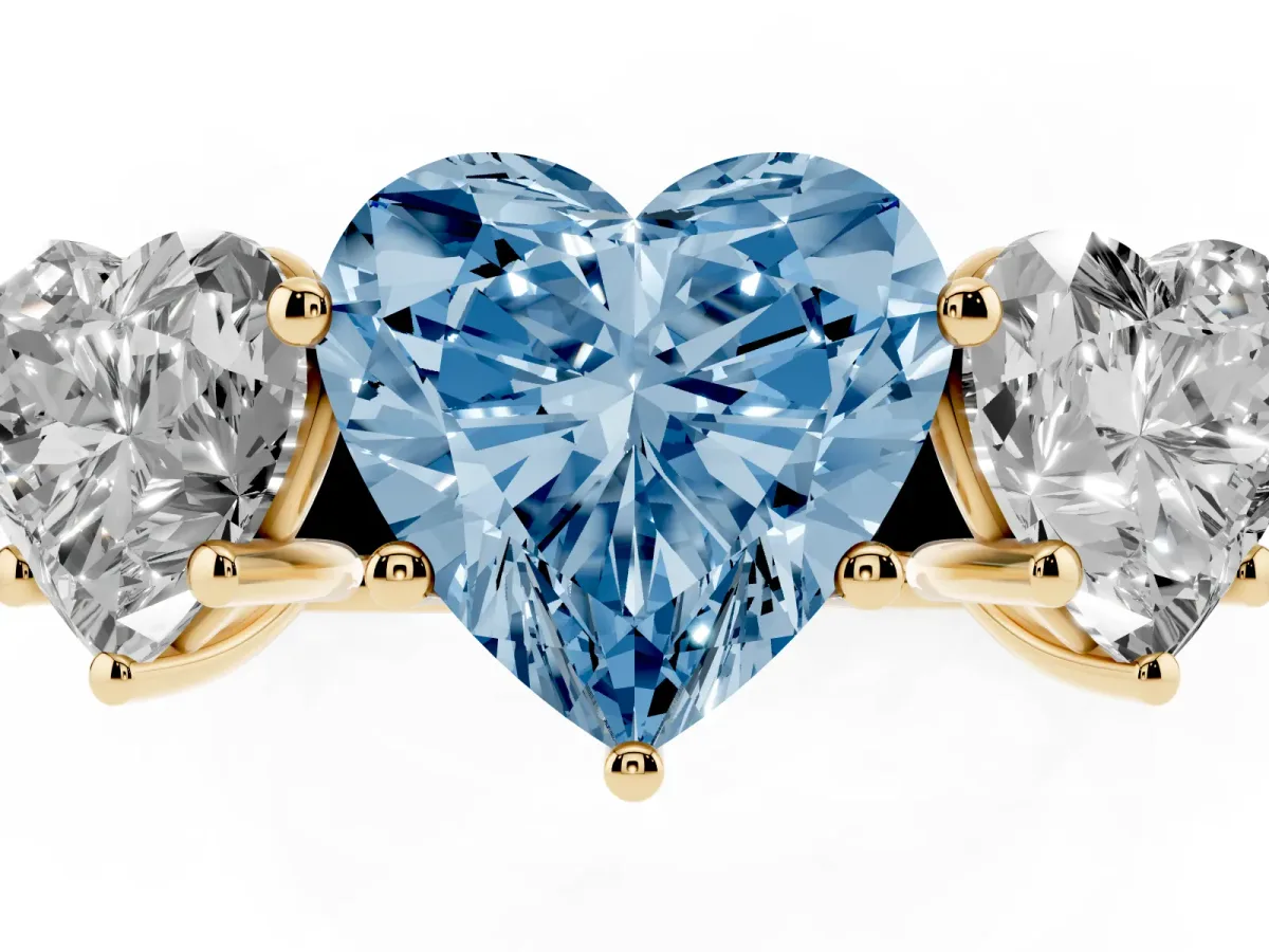 Fancy Blue Heart Cut Three-Stone Diamond Ring with Prong Setting on a Classic Band Yellow gold