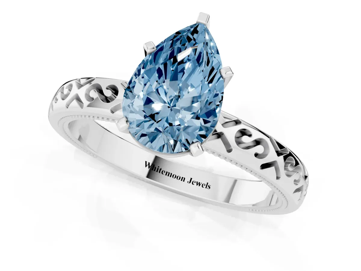 Fancy Blue Pear Cut Solitaire Engagement Ring with Scrollwork Band and Four-Prong Setting Silver