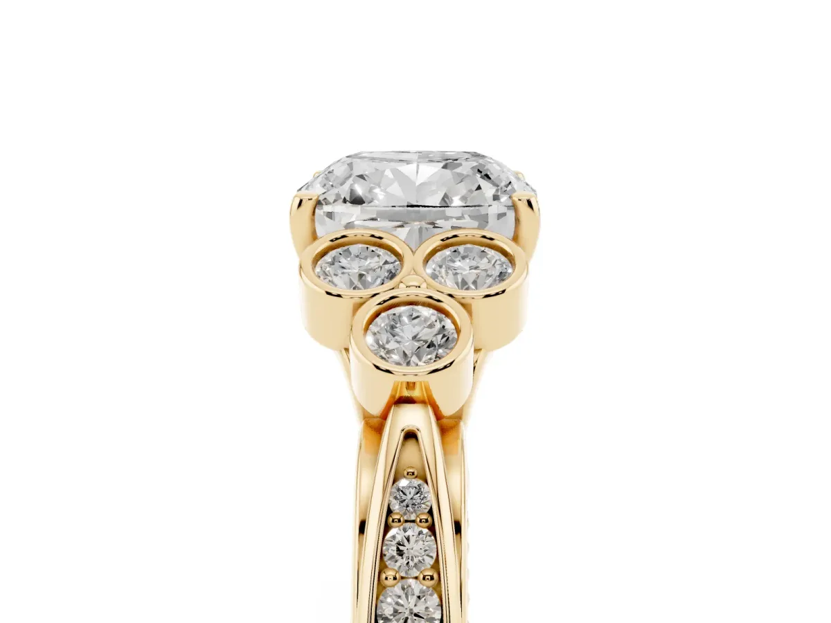 Cushion Cut Cut Diamond Engagement Ring with Bezel Set Round Side Stones and Prong Setting Yellow gold