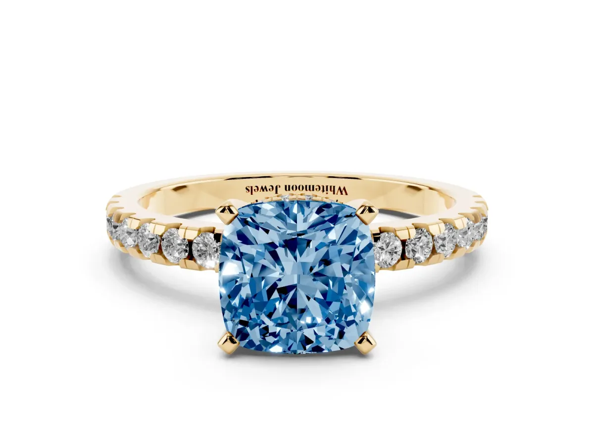 Fancy Blue Cushion Cut Diamond Solitaire Ring with Round Pavé Band and Four-Prong Setting Yellow gold