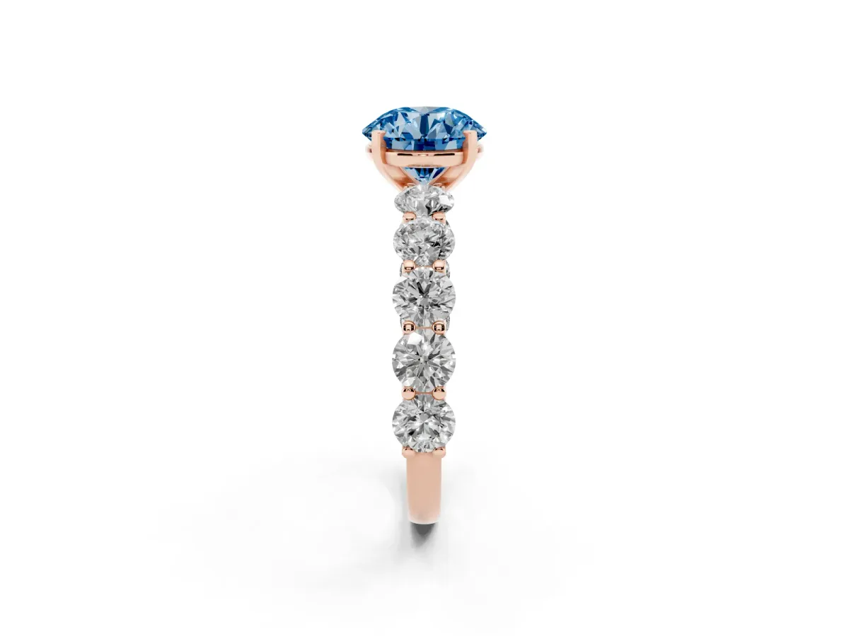 Fancy Blue Round Cut Diamond Prong Setting with Side Stones on a Pave Band Rose gold