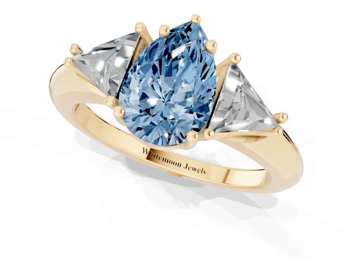 Fancy Blue Three-Stone Pear Cut Diamond Engagement Ring with Trillion Side Stones and Prong Setting Yellow gold