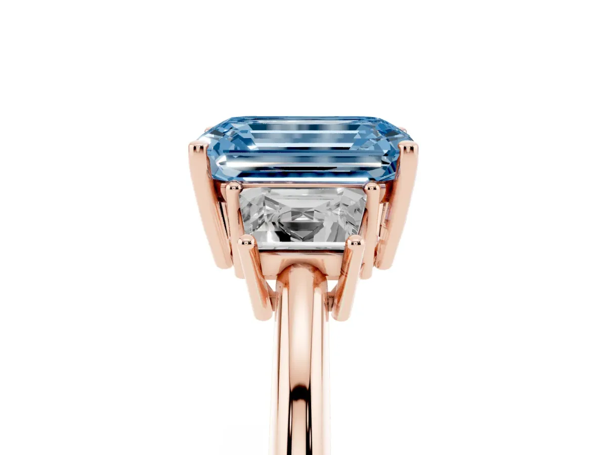 Fancy Blue Emerald Cut Diamond Three-Stone Ring with Trapezoid Side Stones and Prong Setting Rose gold