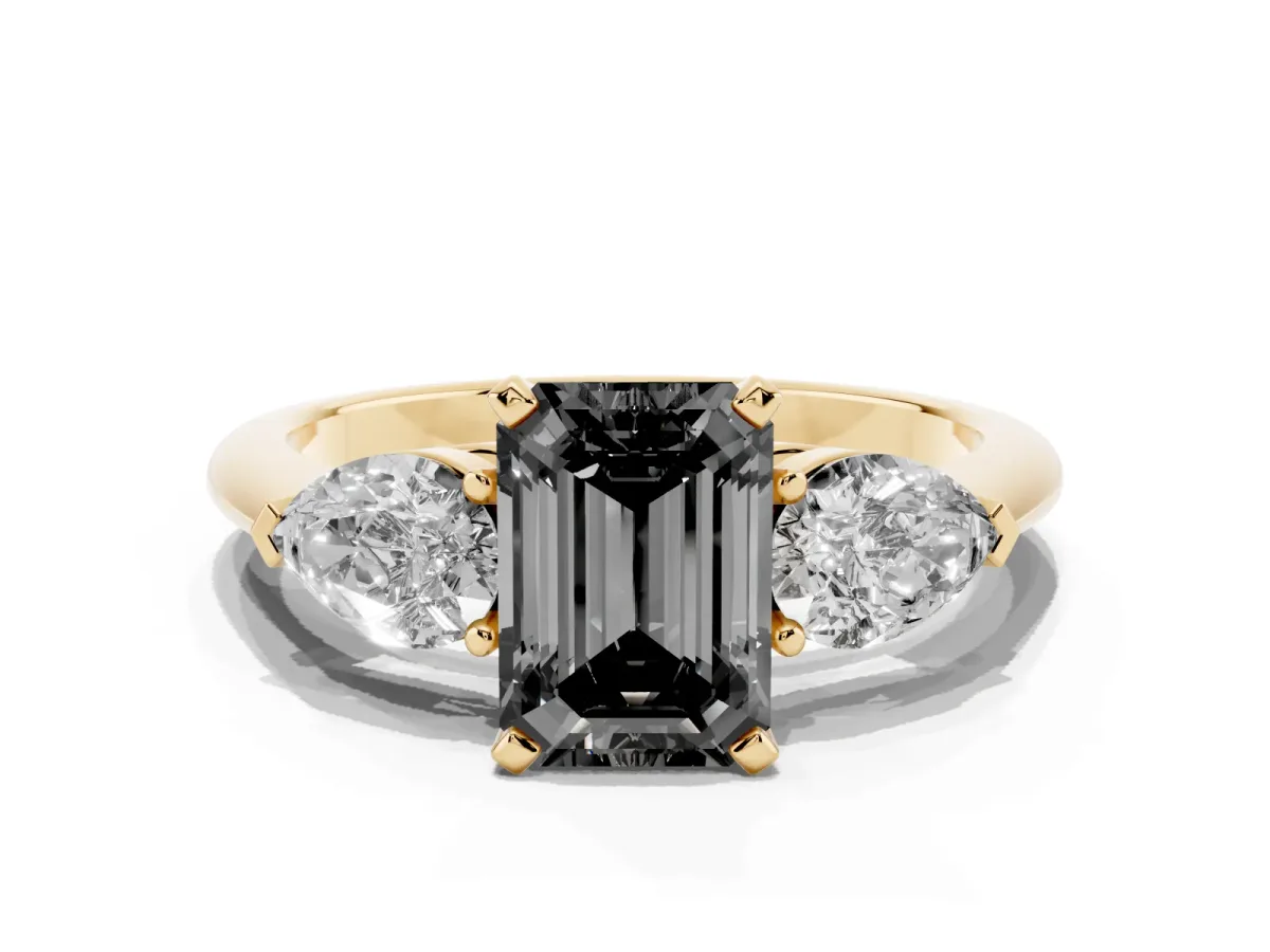 Fancy Black Three-Stone Emerald Cut Diamond Ring with Pear Side Stones and Four-Prong Setting Yellow gold