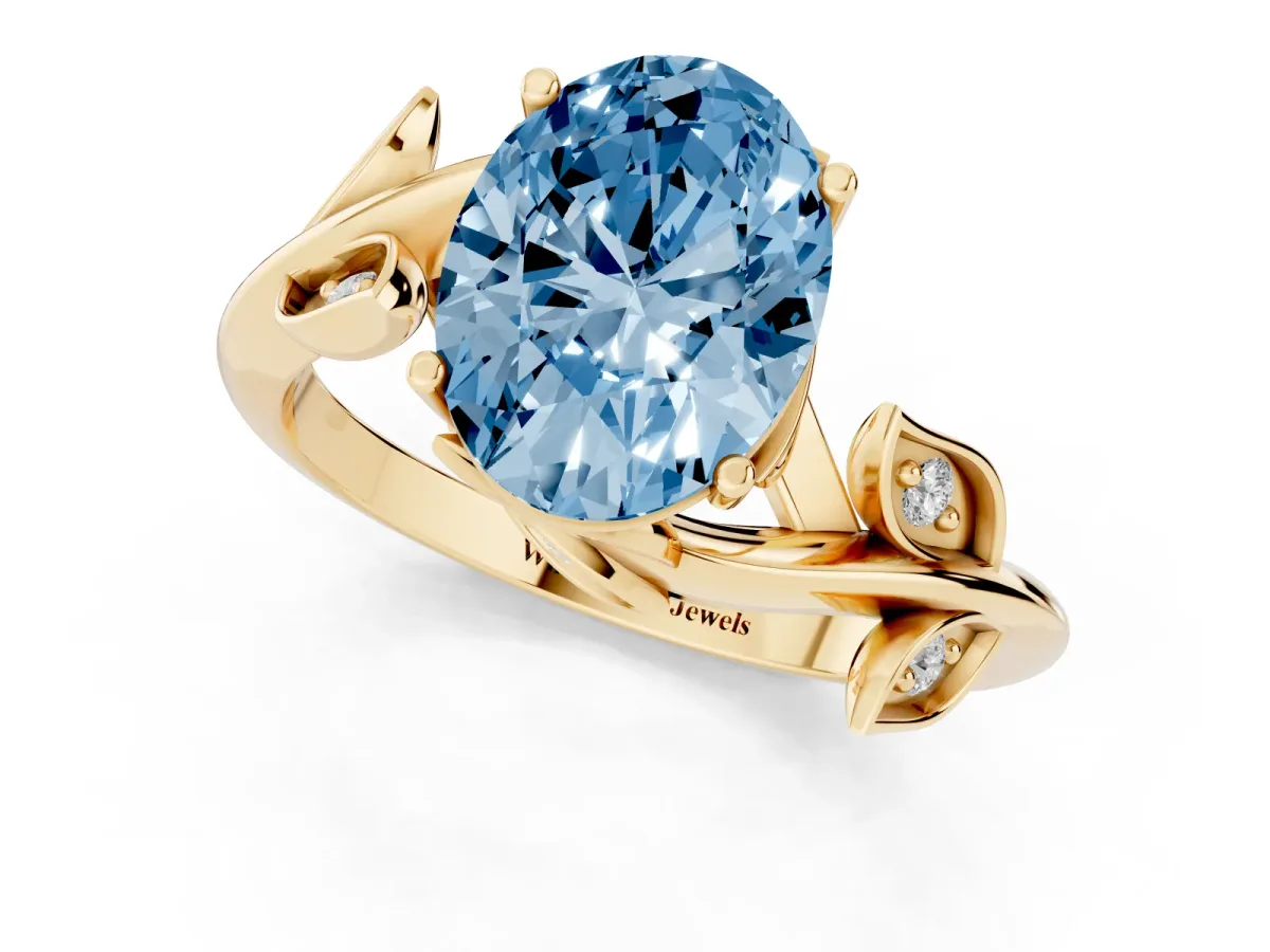 Fancy Blue Oval Cut Solitaire Twist Engagement Ring with Leaf Accents and Prong Setting Yellow gold