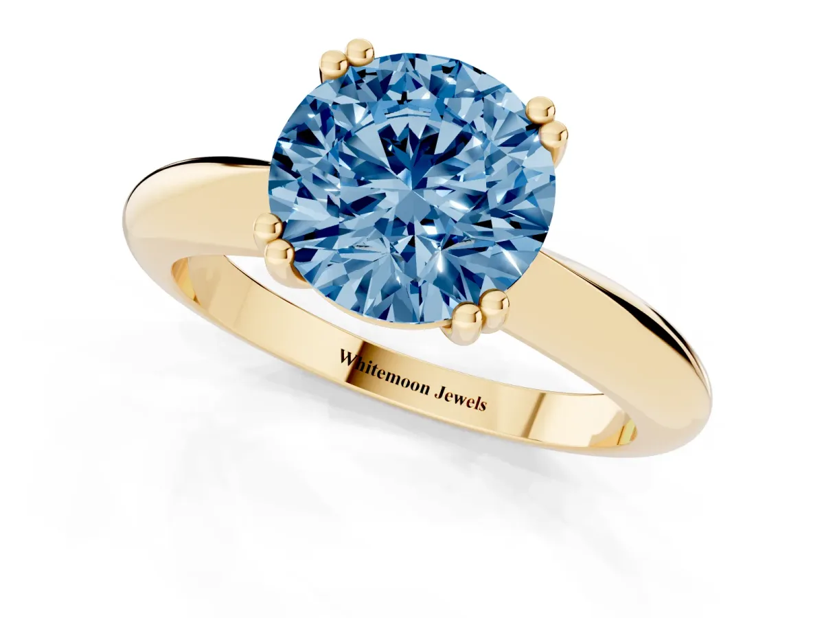 Fancy Blue Round Cut Cut Solitaire Engagement Ring with Tapered Band and Four-Prong Setting Yellow gold