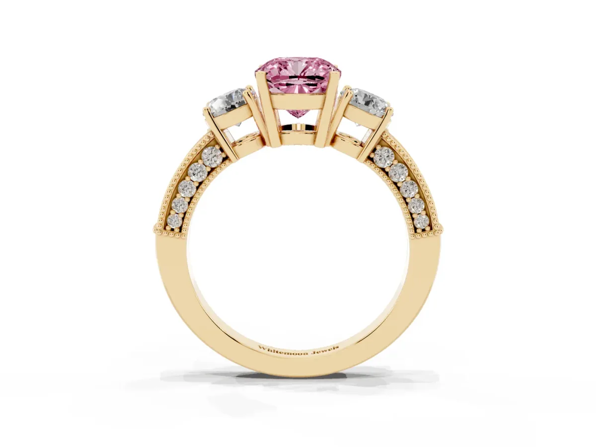 Fancy Pink Cushion Cut Three-Stone Diamond Ring with Pavé Band and Four-Prong Setting Yellow gold