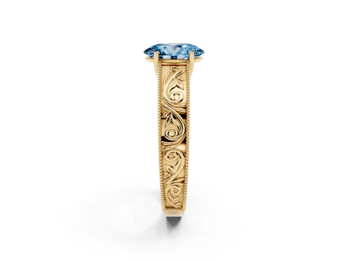 Fancy Blue Oval Cut Diamond Solitaire Ring with Engraved Band and Four-Prong Setting Yellow gold
