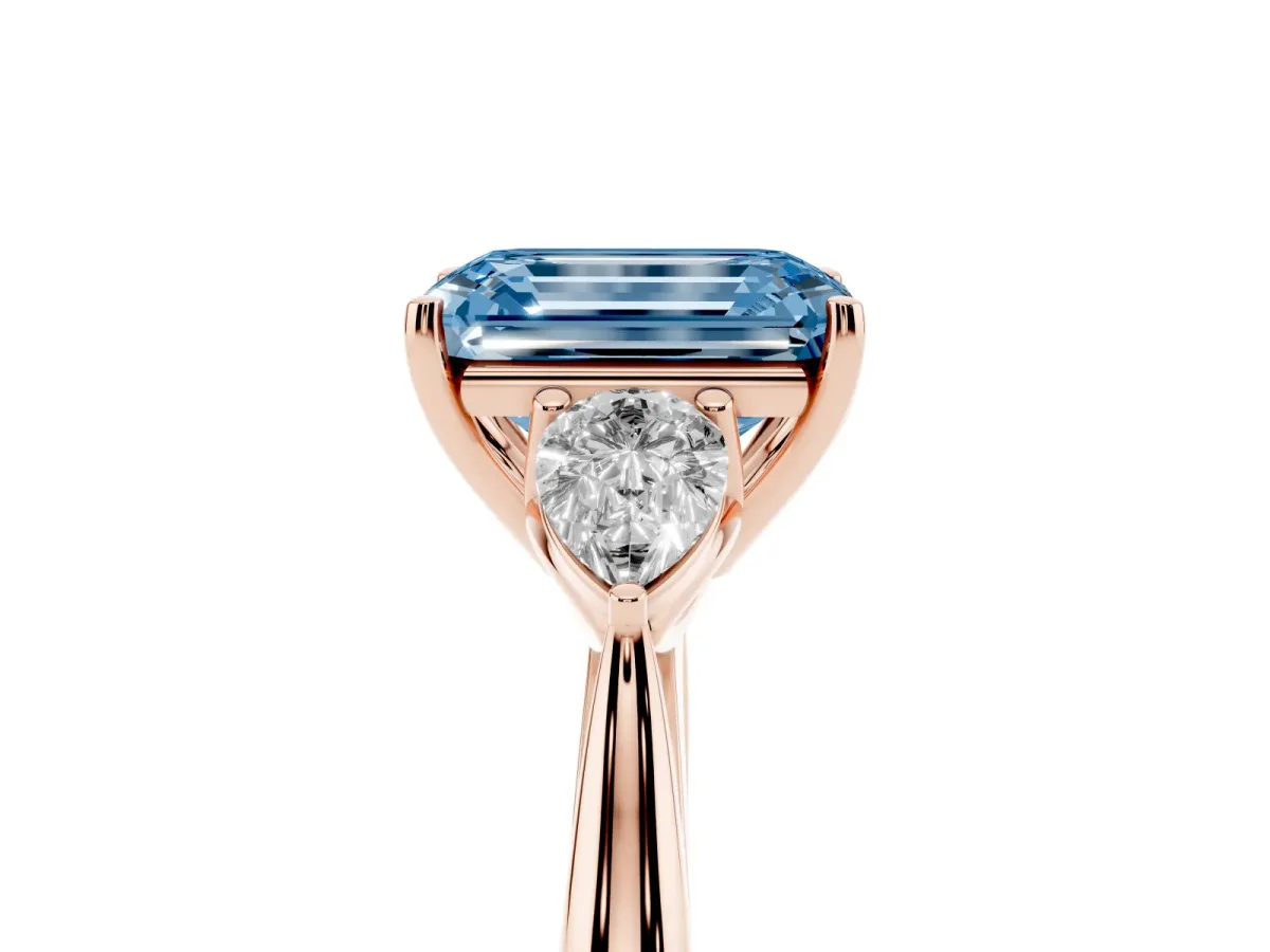 Fancy Blue Three-Stone Emerald Cut Brilliant Diamond Solitaire Ring with Tapered Band and Four-Prong Setting Rose gold