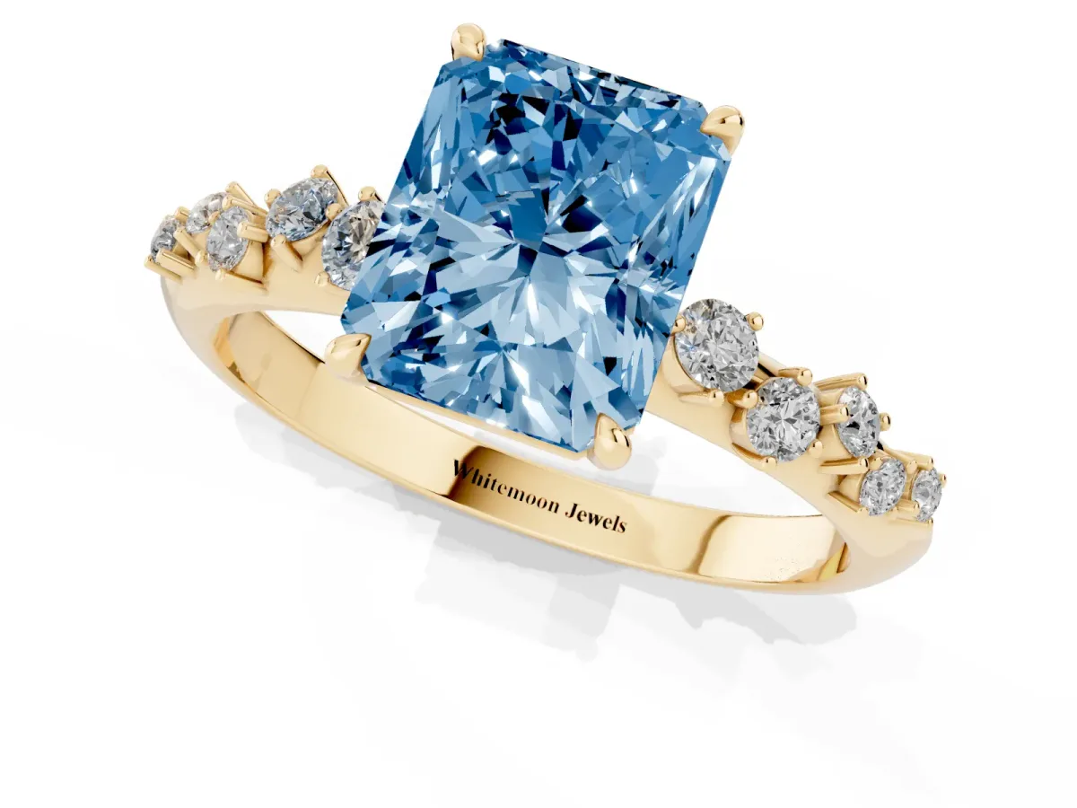 Fancy Blue Radiant Cut Diamond Cluster Side Stone Solitaire Ring with Prong Setting Yellow gold