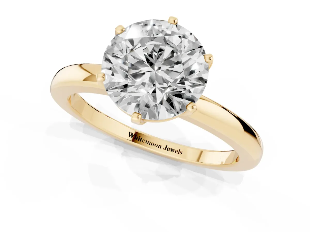 Round Cut Solitaire Diamond Ring with Six-Prong Setting on a Classic Band Yellow gold