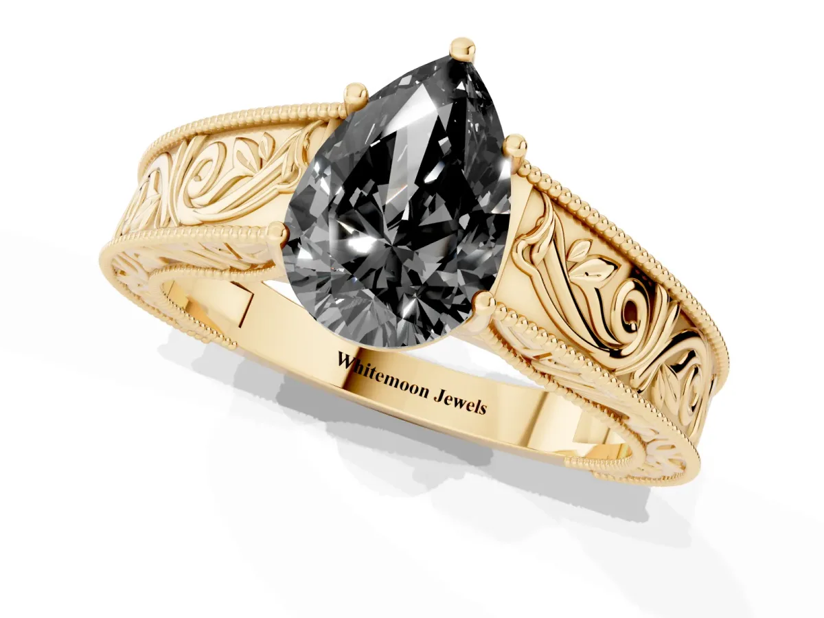 Fancy Black Pear Cut Diamond Solitaire Ring with Engraved Band and Four-Prong Setting Yellow gold