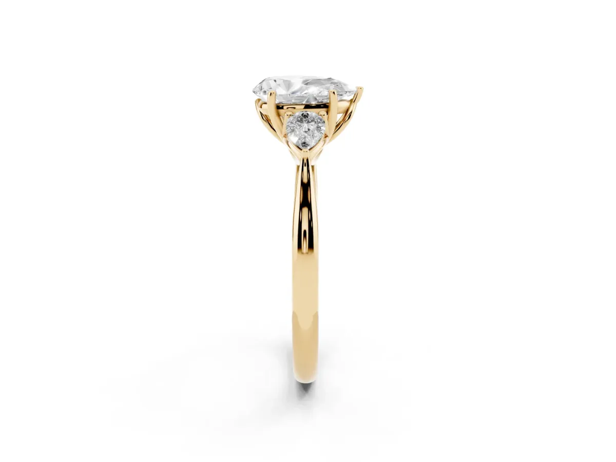 Three-Stone Pear Cut Diamond Ring with Pear Side Stones in Four-Prong Setting Yellow gold