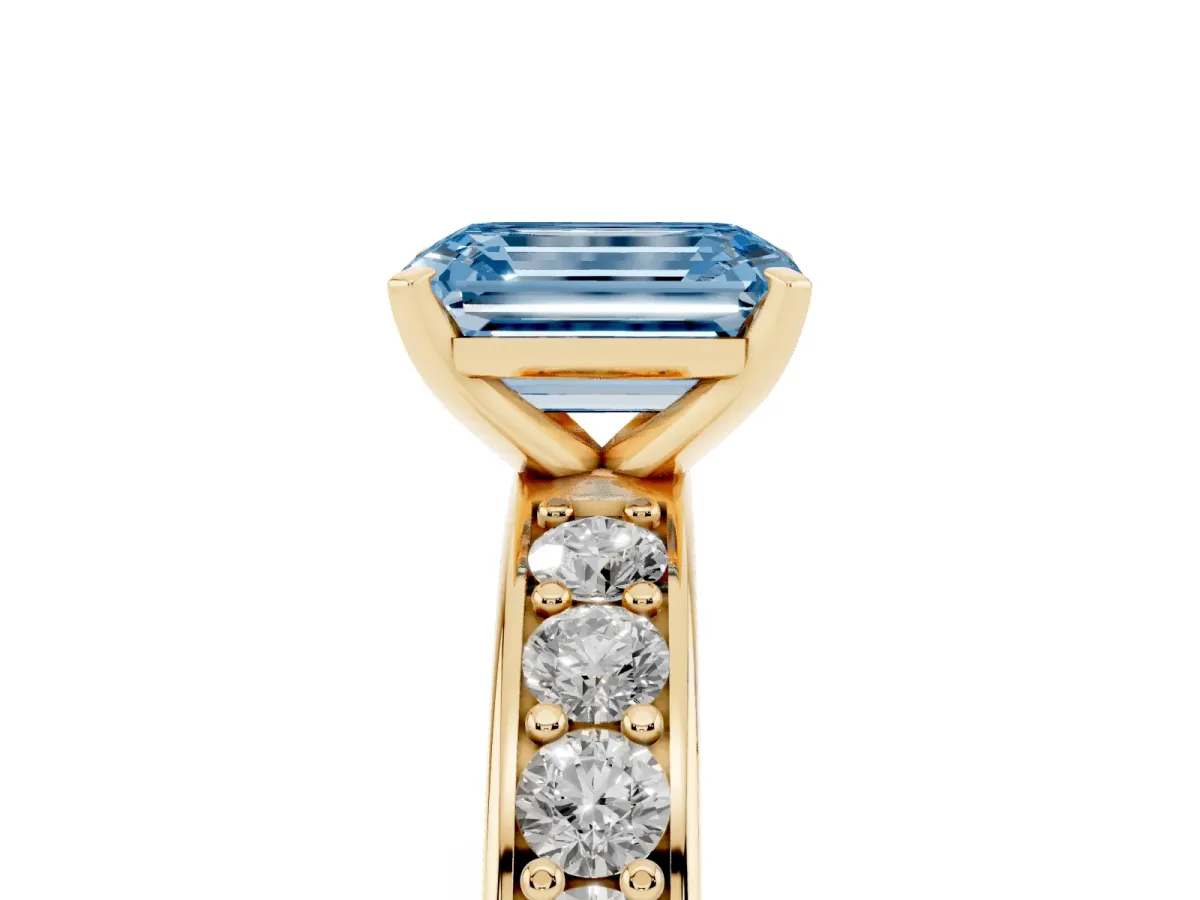 Fancy Blue Emerald Cut Diamond Engagement Ring with Channel Set Round Band and Prong Setting Yellow gold