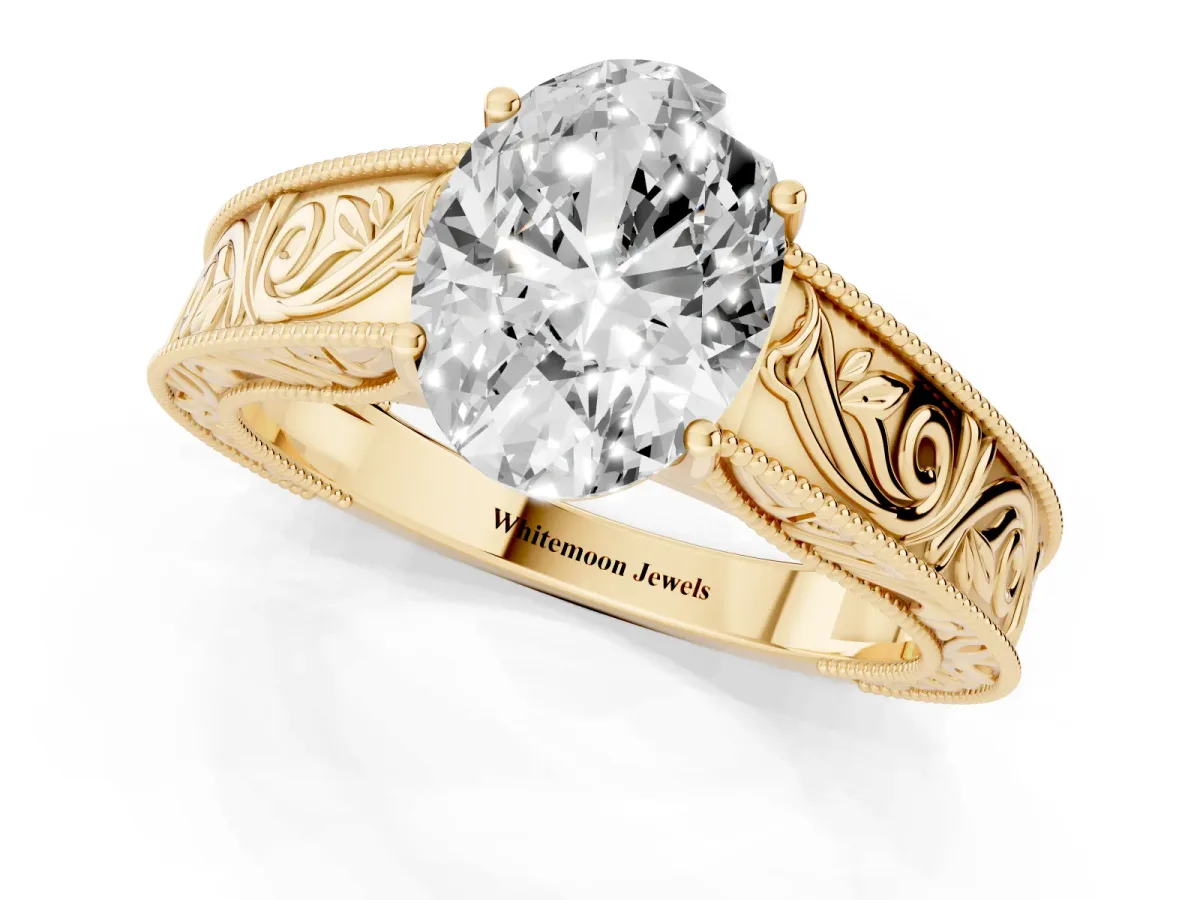 Oval Cut Diamond Solitaire Ring with Engraved Band and Four-Prong Setting Yellow gold