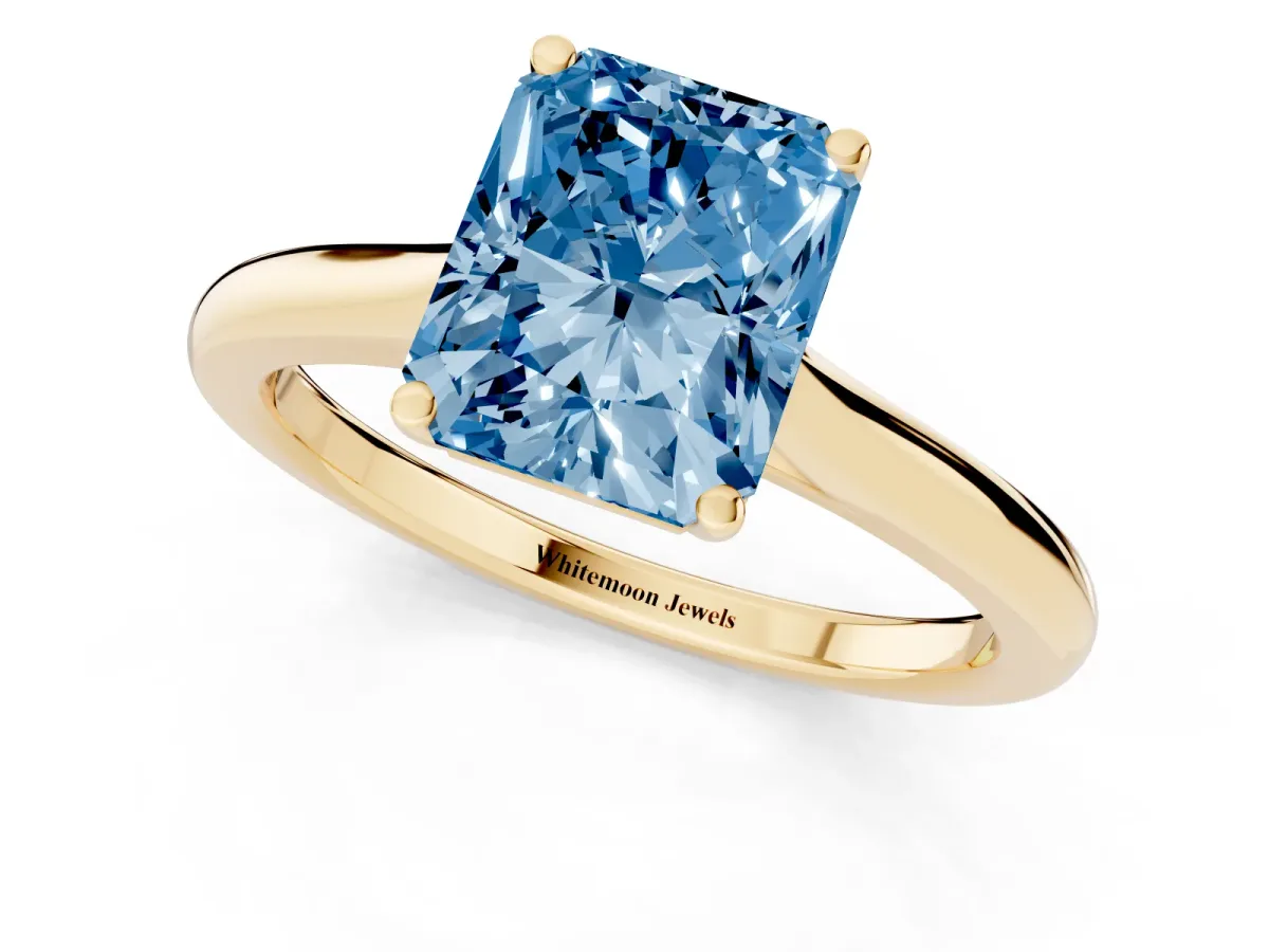 Fancy Blue Radiant Cut Cut Solitaire Ring with Cathedral Band and Four-Prong Setting Yellow gold