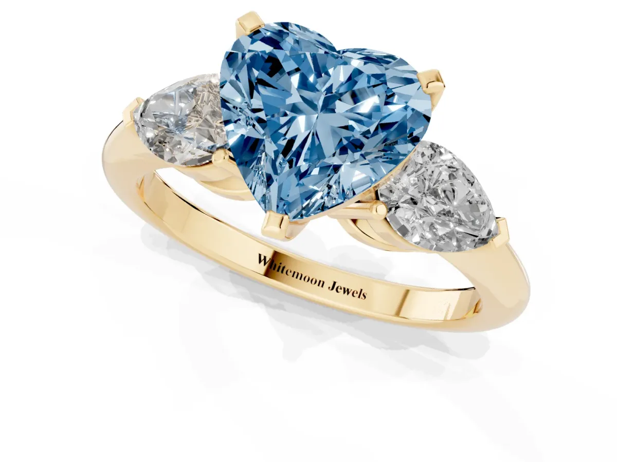 Fancy Blue Three-Stone Heart Cut Diamond Ring with Pear Side Stones and Four-Prong Setting Yellow gold