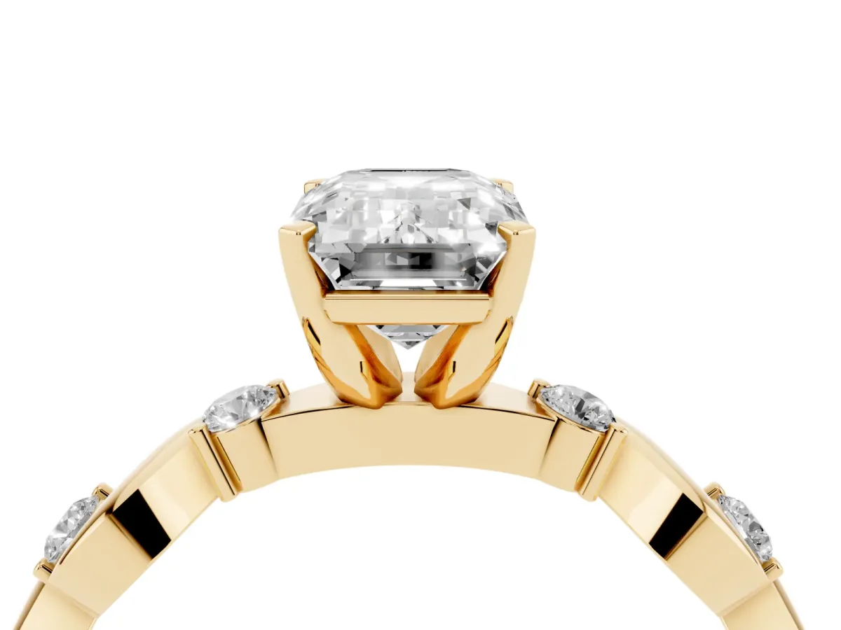 Emerald Cut Diamond Solitaire Twisted Band with Round Accents and Prong Setting Yellow gold