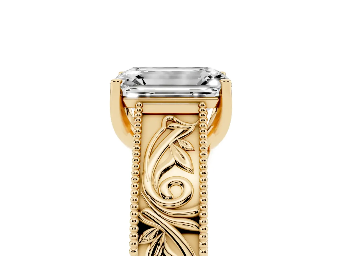 Emerald Cut Diamond Solitaire Ring with Engraved Band and Four-Prong Setting Yellow gold