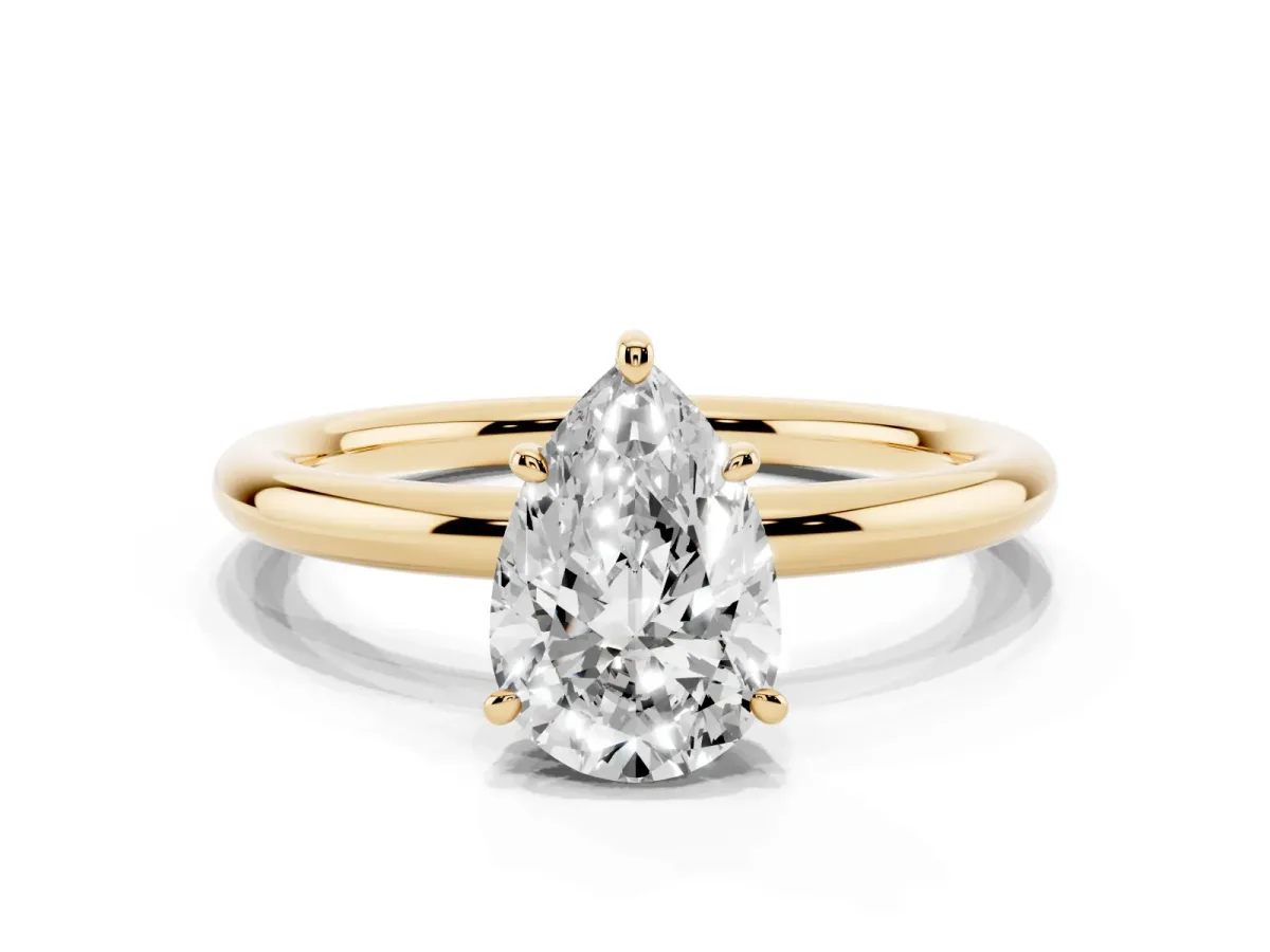 Pear Cut Solitaire Diamond Ring with Four-Prong Setting on a Plain Band Yellow gold
