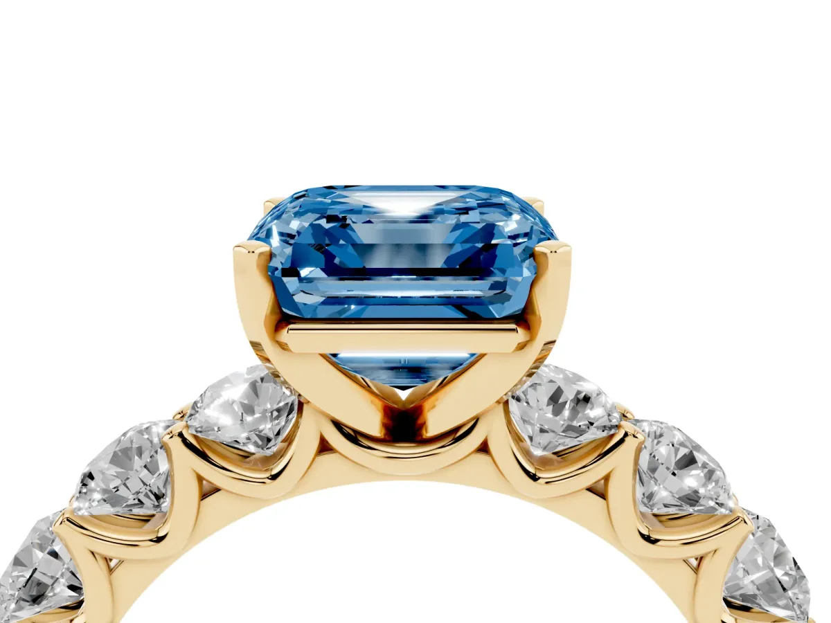 Fancy Blue Asscher Cut Diamond Prong Setting with Side Stones on a Pave Band Yellow gold