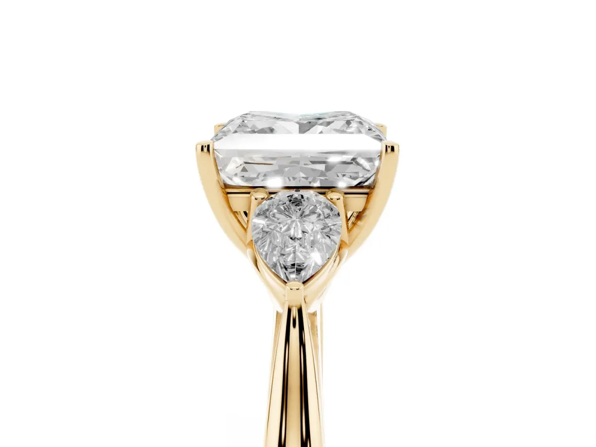 Three-Stone Princess Cut Diamond Ring with Pear Side Stones in Four-Prong Setting Yellow gold