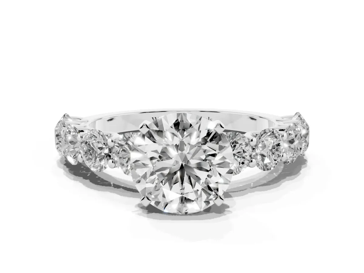 Round Cut Diamond Prong Setting with Side Stones on a Pave Band Silver