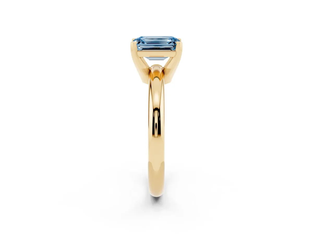 Fancy Blue Emerald Cut Diamond Solitaire Engagement Ring with Round Band and Four-Prong Setting Yellow gold