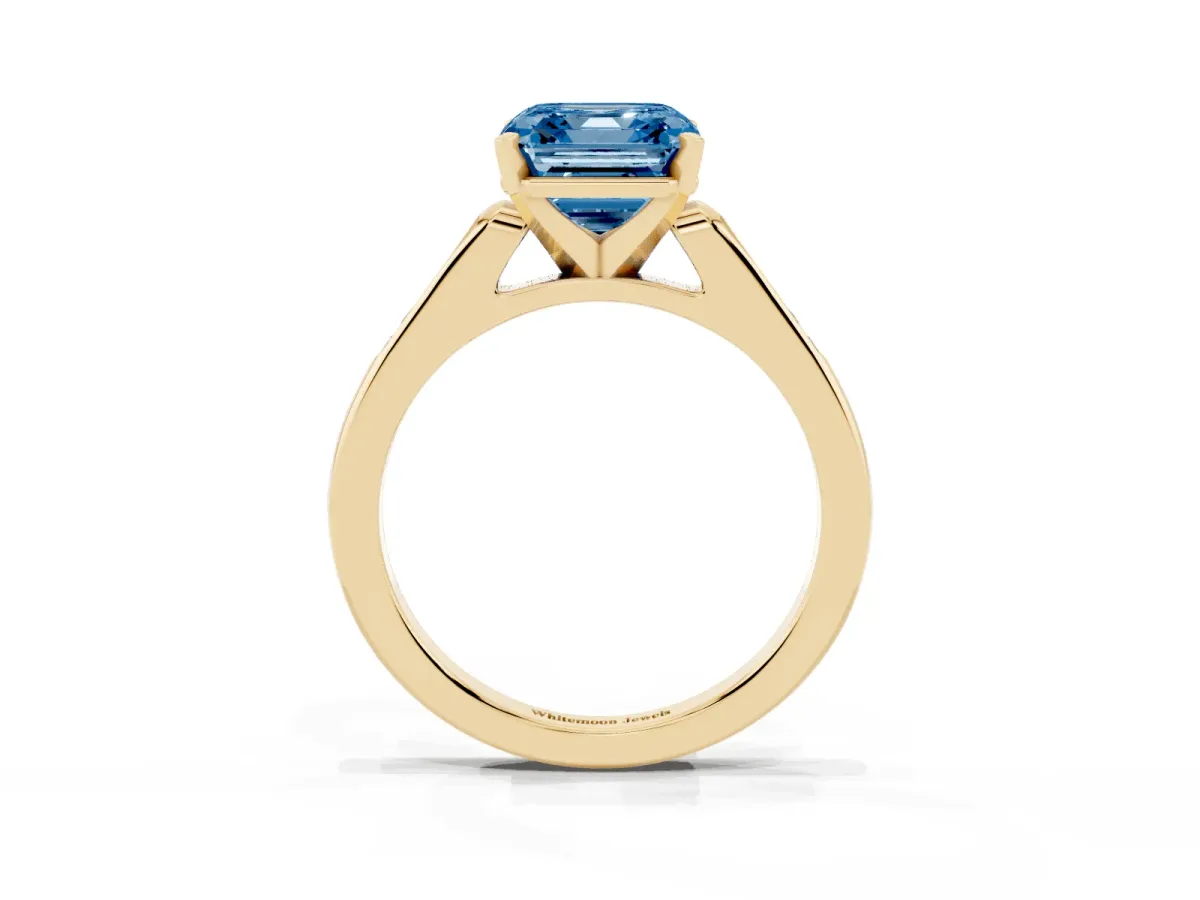 Fancy Blue Asscher Cut Diamond Solitaire Ring with Channel Set Round Band and Prong Setting Yellow gold