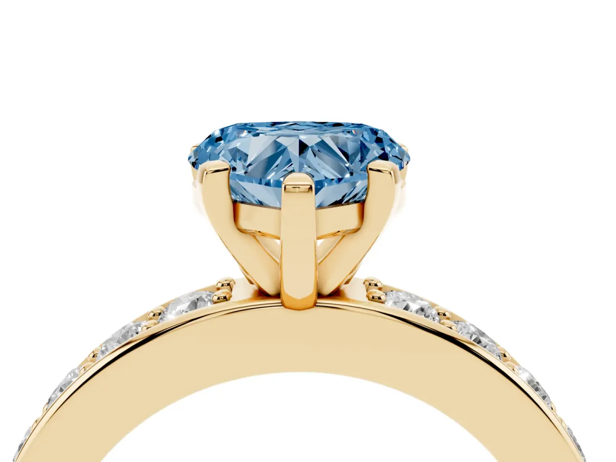 Fancy Blue Heart Cut Diamond Engagement Ring with Channel Set Round Band and Prong Setting Yellow gold