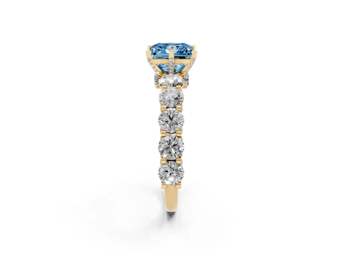 Fancy Blue Princess Cut Diamond Side Stone Engagement Ring with Four-Prong Setting Yellow gold