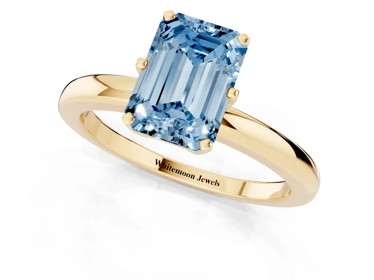 Fancy Blue Emerald Cut Solitaire Diamond Ring with Six-Prong Setting on a Classic Band Yellow gold